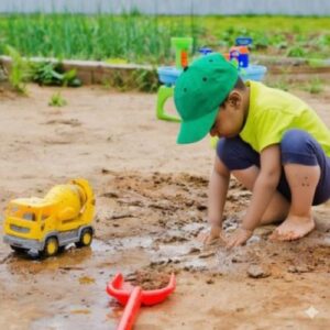 Child playing with farm toys at Greenroots organic farm near Gangapur dam agro tourism destination
